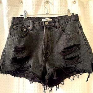 Grey/black ripped denim shorts.
